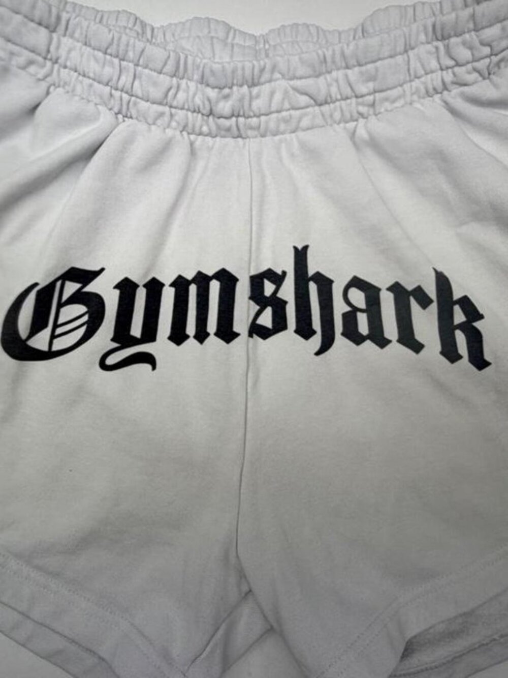 gymshark strength department white sweat shorts w/ gothic logo (XL)